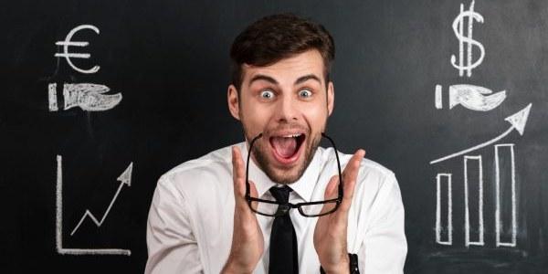 Amazed bearded businessman takes off his glasses