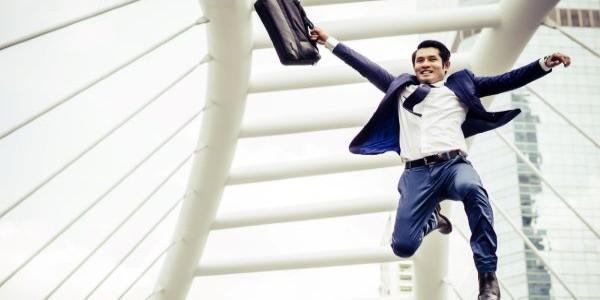 Young businessman with a briefcase running in a city
