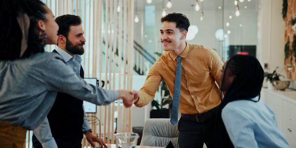 Business man woman and handshake at meeting with team