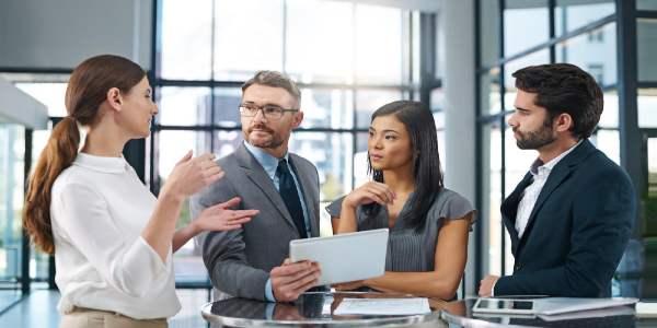 Meeting in office with tablet for business report or information