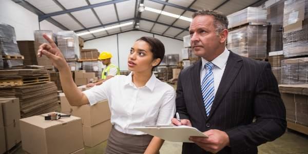 Warehouse manager showing something to her boss