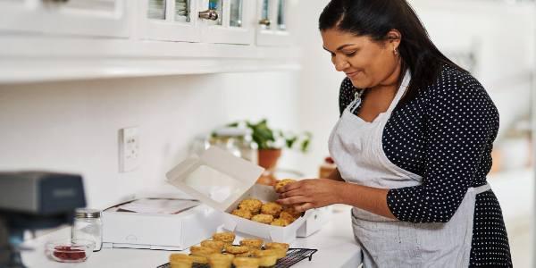 Everyone loves my pies cropped shot of a baker packing freshly baked pies into boxes