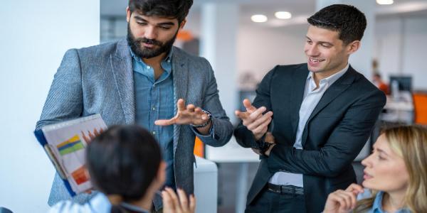 Business people reviewing paperwork in conference room