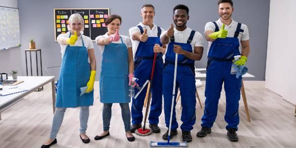 Janitors showing thumb up sign in the office