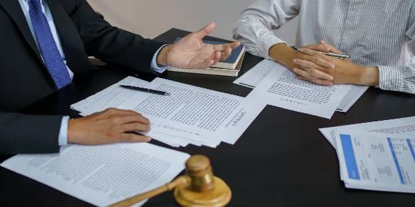 Lawyer legal counsel presents to the client a signed contract