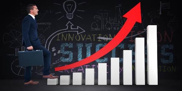 Businessman climbing with briefcase against brainstorm in grey room