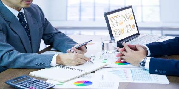 Businessmen reviewing business performance and target planning for a new budget year