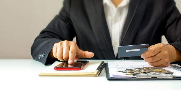 Using mobile phone using credit card to pay credit card payment concept
