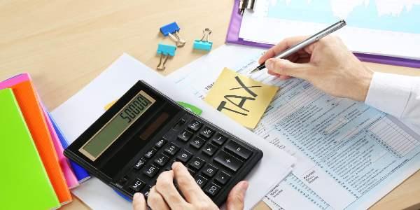 Man filling income tax return form closeup
