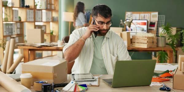 Phone call man and laptop for delivery of small business of ecommerce