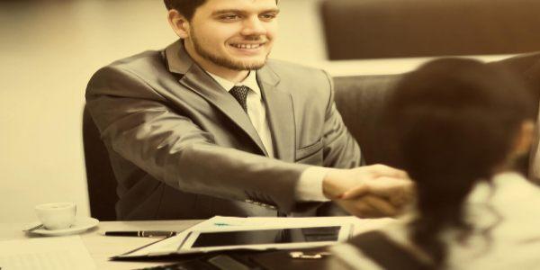 Business people shaking hands finishing up a meeting in office
