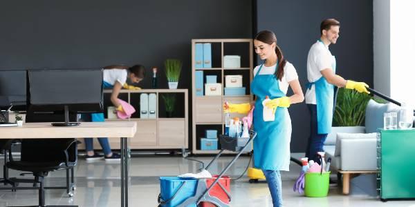 Group of cleaning professionals working in business office