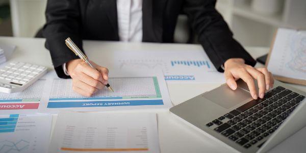 Documents business woman and accountant reading report for financial data