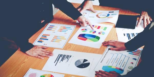 Business people discussing with charts on table