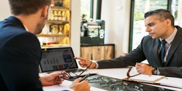 Two businessmen cafe meeting laptop concept