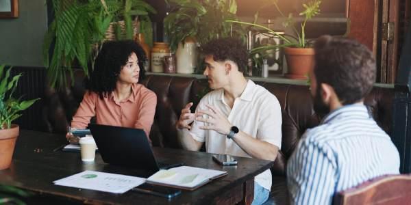 Business people and discussion with laptop in cafe for budget and planning
