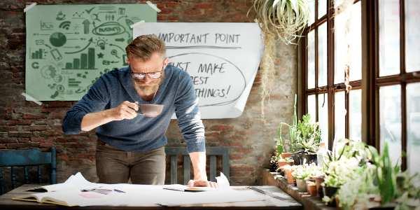 Businessman working while having a cup of coffee