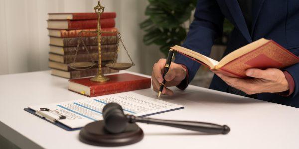 Male lawyer working with law book a legal contract