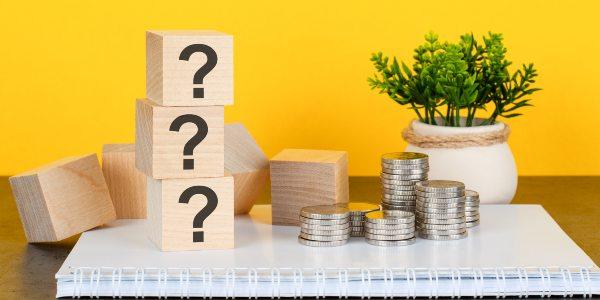 three-question-marks-wooden-blocks-stack-yellow-background